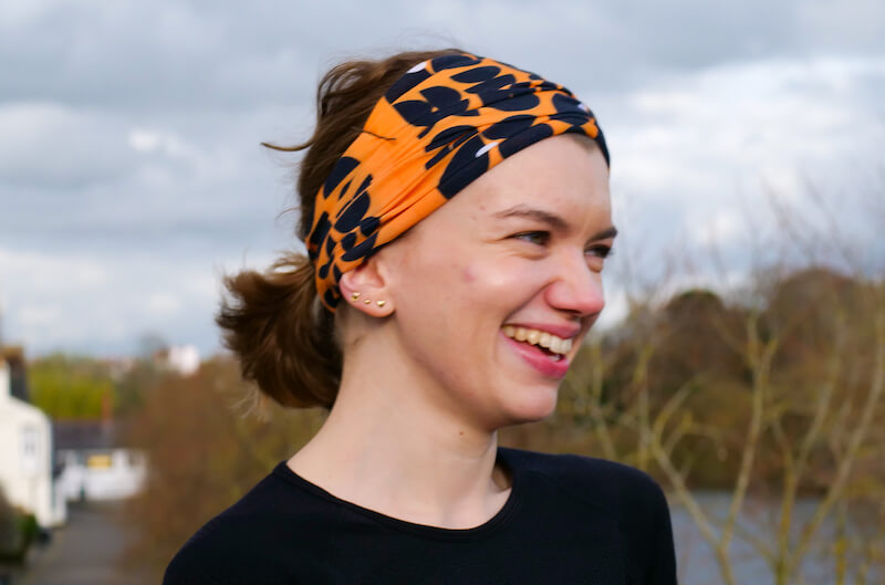 An image of Emily in Chester wearing an orange buff smiling